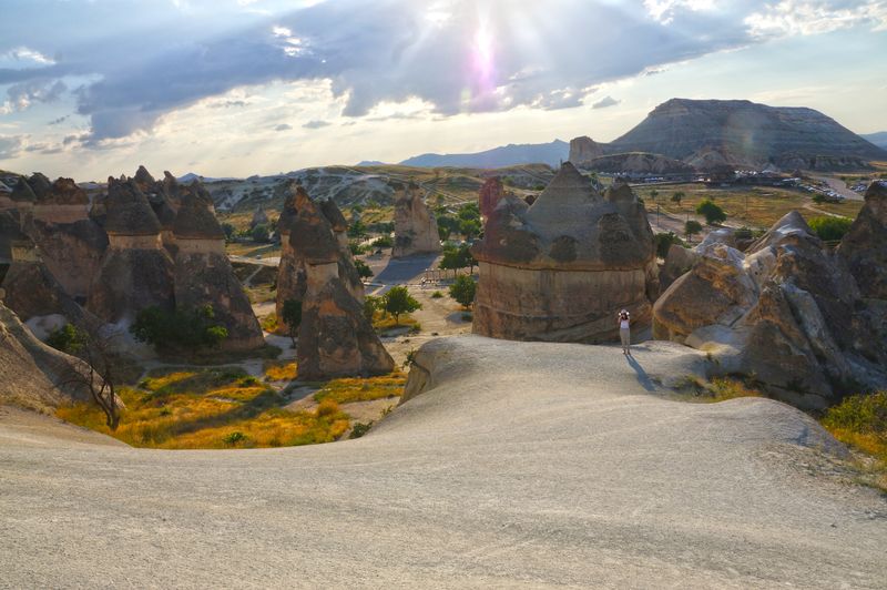 Cone-shaped fairy chimneys rising at Paşabağları under low sun.