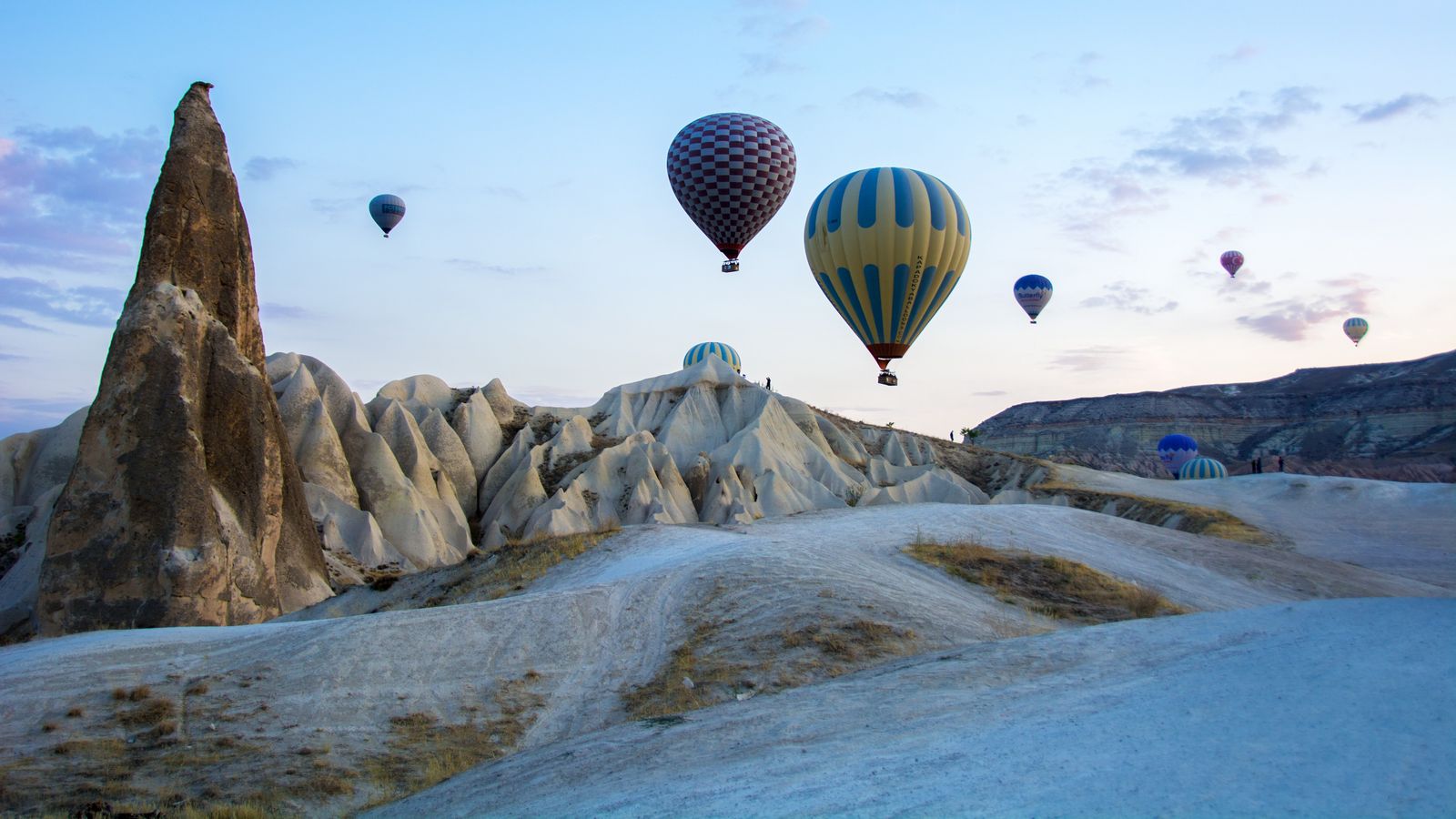 Hot-air balloons drifting above Cappadocia’s fairy chimneys at sunrise.