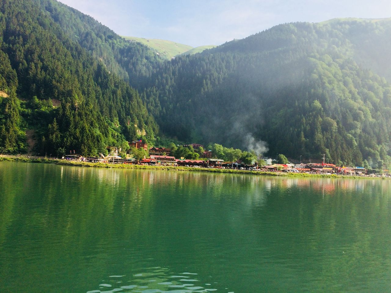 Uzungöl and its lakeside village enclosed by densely green mountain slopes.