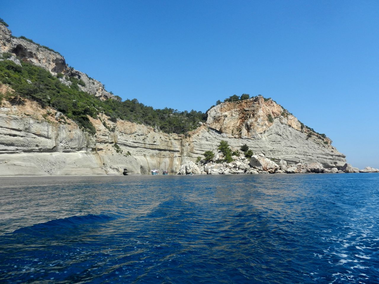 Rocky cliffs and clear blue water along the Mediterranean coast.