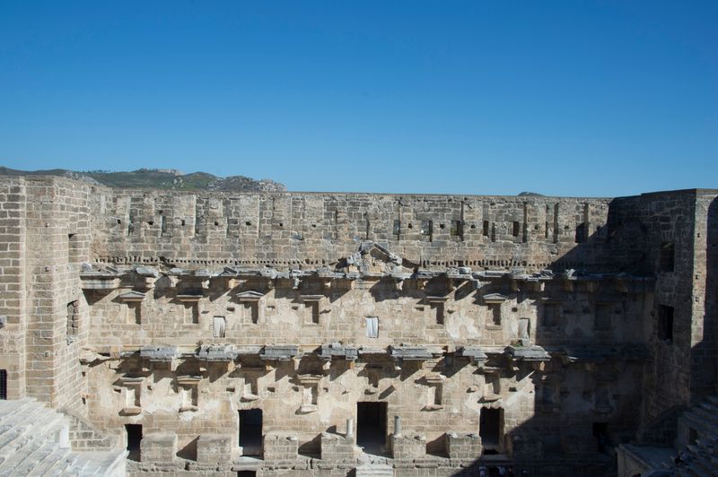 The monumental stage facade and stone architecture of the ancient theatre of Aspendos.