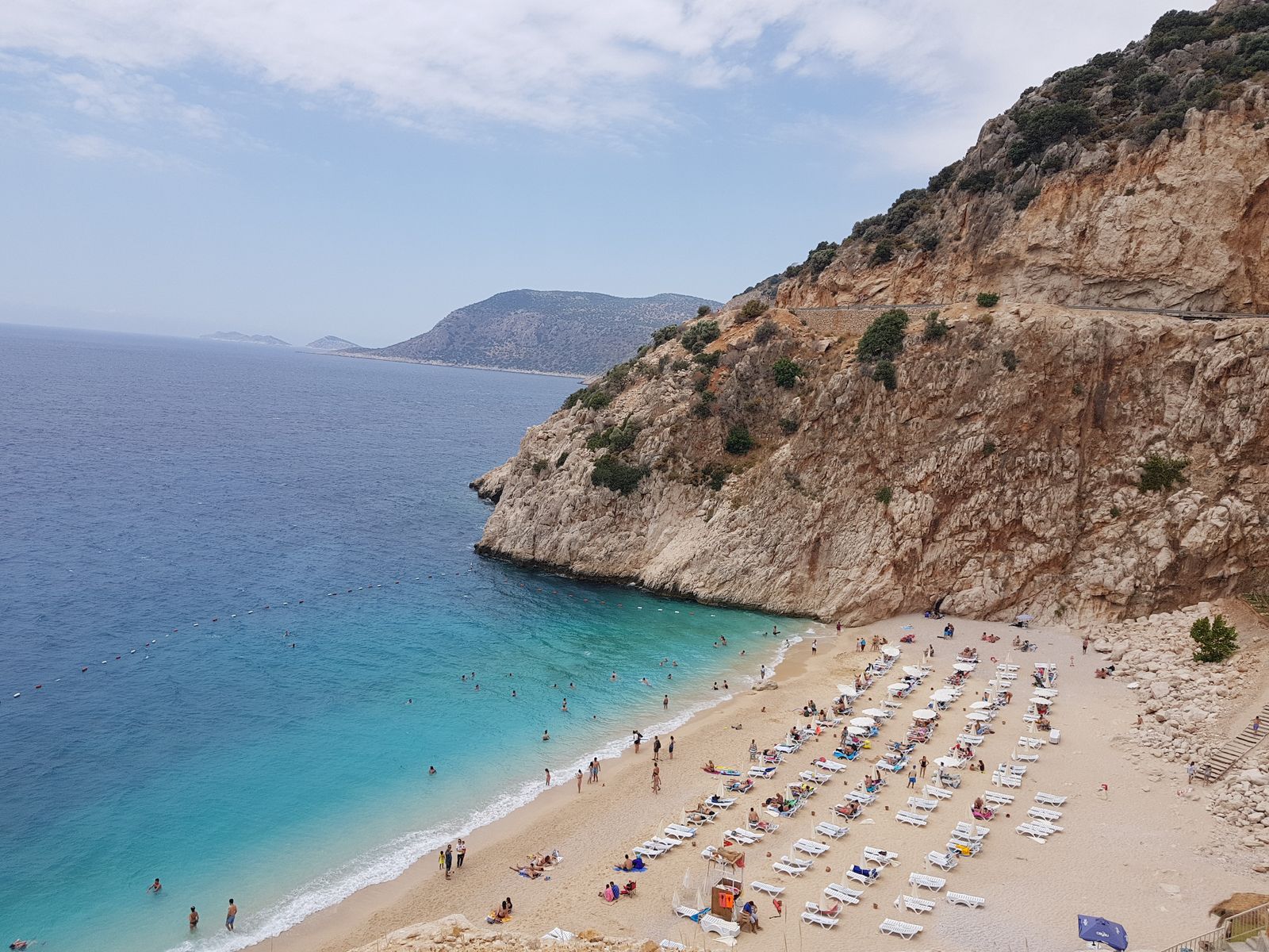 Turquoise Kaputaş Beach nestled between steep coastal cliffs.