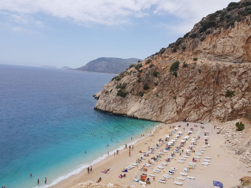 Turquoise Kaputaş Beach nestled between steep coastal cliffs.