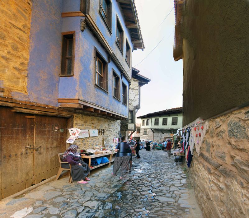 A cobbled lane between painted, overhanging Ottoman houses in Cumalıkızık.