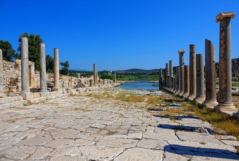 The colonnaded main avenue and stone paving of the ancient city of Patara.